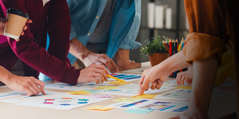 Value 4 Image featuring table of sticky notes as group brainstorms