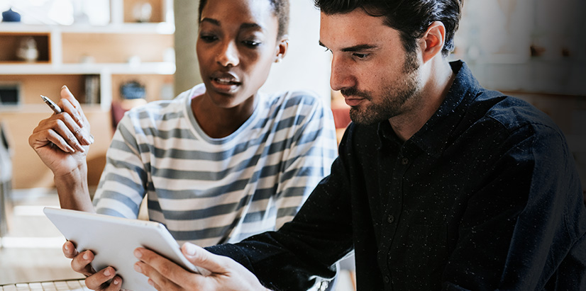 Value 9 Image featuring black woman talking to white man over something on a tablet